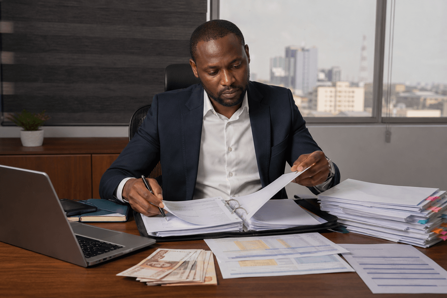 Nigerian procurement professional reviewing enterprise vendor onboarding, SLA, and invoice documentation.